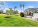 Screened pool with manicured lawn, mature landscaping, and nearby community amenities at 6170 Misty Oaks Dr, Sarasota, FL 34243