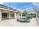 Screened-in pool and spa with tiled deck and comfortable seating area for relaxation and enjoyment at 6170 Misty Oaks Dr, Sarasota, FL 34243