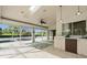 Bright sunroom boasts a beverage bar, seating, tile flooring, and views of the lanai and outdoor living area at 6170 Misty Oaks Dr, Sarasota, FL 34243