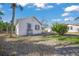 Exterior view of guest house with lush tropical landscaping, creating a secluded and inviting retreat at 624 Norsota Way, Sarasota, FL 34242