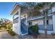 Condo exterior featuring stairway, balcony, garden, and light gray and white color scheme at 6800 Placida Rd # 2017, Englewood, FL 34224