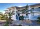 Exterior of a condo unit with a balcony, palm trees, and blue and gray accents at 6800 Placida Rd # 2017, Englewood, FL 34224