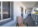 Condo hallway with a chair, decorative mat, and a view of the building walkway at 6800 Placida Rd # 2017, Englewood, FL 34224