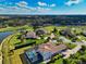 Aerial view of a home with screened in pool, pond and golf course. Excellent landscaping at 7315 Bianco Duck Ct, Sarasota, FL 34240