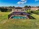 Aerial view of backyard, highlighting the screened-in pool and spacious green lawn at 7315 Bianco Duck Ct, Sarasota, FL 34240