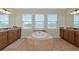 Luxurious bathroom featuring a soaking tub, granite countertops, and ample natural light at 7315 Bianco Duck Ct, Sarasota, FL 34240
