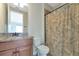 Bathroom featuring wood cabinets and shower with decorative curtain at 7315 Bianco Duck Ct, Sarasota, FL 34240