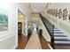 Spacious two-story foyer with hardwood floors, staircase and gallery, creating a grand entrance at 7315 Bianco Duck Ct, Sarasota, FL 34240