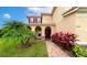 Inviting facade of a two-story home, showcasing red shutters and decorative front yard plants at 7315 Bianco Duck Ct, Sarasota, FL 34240