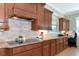 Stylish kitchen with custom cabinets, granite countertops, tile backsplash, and modern appliances at 7315 Bianco Duck Ct, Sarasota, FL 34240