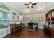 Well-lit office space with hardwood floors, large windows, and built-in cabinets, perfect for work or hobbies at 7315 Bianco Duck Ct, Sarasota, FL 34240