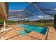 Lovely screened pool with attached spa, brick patio, and views of backyard and the pond at 7315 Bianco Duck Ct, Sarasota, FL 34240