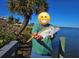 A fisherman displaying catch in front of waterfront scenery at 10428 Marion St, Englewood, FL 34224