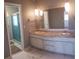 Bathroom featuring double sinks, granite countertop, cabinets, and open closet space at 121 Van Dyck Dr, Nokomis, FL 34275