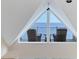 Attic space with a triangular window and furnishings, offering a unique and cozy retreat at 16 Tidy Island Blvd # 16, Bradenton, FL 34210