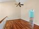 Spacious bedroom with hardwood floors, neutral walls, a ceiling fan, and access to another room at 16 Tidy Island Blvd # 16, Bradenton, FL 34210