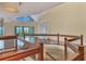An upstairs bonus room boasts water views, custom bookshelves, hardwood floors, and a decorative glass railling at 16 Tidy Island Blvd # 16, Bradenton, FL 34210