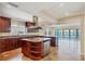 Gourmet kitchen features custom cabinets, granite countertops, island, and scenic water views at 16 Tidy Island Blvd # 16, Bradenton, FL 34210