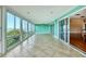 The bright lanai features tile floors, turquoise walls, sliding glass doors and windows, with great water views at 16 Tidy Island Blvd # 16, Bradenton, FL 34210