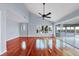 Bright living room boasts a ceiling fan, vaulted ceilings, hardwood floors, and sliding glass doors at 16 Tidy Island Blvd # 16, Bradenton, FL 34210
