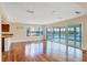 A large living room showcases hardwood floors, lots of natural light, and sliding glass doors that provide a water view at 16 Tidy Island Blvd # 16, Bradenton, FL 34210