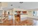 Open-concept living space boasts gleaming hardwood floors and seamless transition to kitchen and outdoor spaces at 16 Tidy Island Blvd # 16, Bradenton, FL 34210