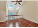 Bright room featuring skylights, vaulted ceilings with fan, hardwood floors, and glass-paneled railing at 16 Tidy Island Blvd # 16, Bradenton, FL 34210