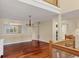 Bright living room featuring hardwood floors, neutral walls, a chandelier, and a window with white shutters at 16 Tidy Island Blvd # 16, Bradenton, FL 34210