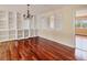 A large living room featuring hardwood floors, built-in shelving, neutral walls, and a window with white shutters at 16 Tidy Island Blvd # 16, Bradenton, FL 34210