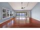 Large living room features hardwood floors, a ceiling fan, and sliding glass doors with scenic views at 16 Tidy Island Blvd # 16, Bradenton, FL 34210