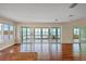 A spacious living room features hardwood floors and sliding glass doors leading to sun room with water views at 16 Tidy Island Blvd # 16, Bradenton, FL 34210