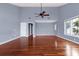 Expansive living room with hardwood floors, high ceilings, ceiling fan, and a large window at 16 Tidy Island Blvd # 16, Bradenton, FL 34210