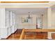 Bright living room with hardwood floors, white built-in shelving, a chandelier, and a window with white shutters at 16 Tidy Island Blvd # 16, Bradenton, FL 34210