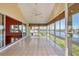 Bright sunroom with tile floors, ceiling fan, and large windows offering beautiful waterfront views at 16 Tidy Island Blvd # 16, Bradenton, FL 34210