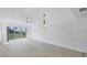 Vacant living room with tile floors and view to lush landscaping at 3810 Gulf Of Mexico Dr # F105, Longboat Key, FL 34228