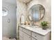 Bathroom with marble counters, white cabinets, and a glass-enclosed shower at 3930 Red Rock Way, Sarasota, FL 34231