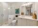 Bright bathroom with glass shower, patterned wallpaper, white vanity, and a decorative art accent at 3930 Red Rock Way, Sarasota, FL 34231