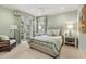 Inviting bedroom with pale green walls, matching patterned fabrics, and balcony access at 3930 Red Rock Way, Sarasota, FL 34231