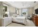 Comfortable bedroom features neutral walls, white furnishings, natural light, and pleasing accent colors at 3930 Red Rock Way, Sarasota, FL 34231