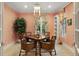 Cozy dining area with a decorative light fixture, patterned wallpaper, and seating for four at 3930 Red Rock Way, Sarasota, FL 34231
