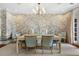 Elegant dining room featuring a chandelier, decorative wallpaper, and seating for six guests at 3930 Red Rock Way, Sarasota, FL 34231