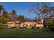 Elegant home exterior with manicured lawn, arched entryway, and a red tile roof at 3930 Red Rock Way, Sarasota, FL 34231