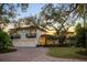 Stately home with a red-tiled roof, a three-car garage, and manicured landscaping at 3930 Red Rock Way, Sarasota, FL 34231