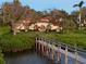 Beautiful exterior view with lush greenery, dock, and serene waterfront at 3930 Red Rock Way, Sarasota, FL 34231