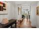 Bright hallway with wood floors, wainscoting and views through french doors at 3930 Red Rock Way, Sarasota, FL 34231