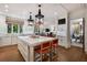 Open kitchen with a large center island, pendant lighting, and views into the living spaces at 3930 Red Rock Way, Sarasota, FL 34231