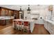 Spacious kitchen featuring a large island with seating, stainless steel appliances, and hardwood floors at 3930 Red Rock Way, Sarasota, FL 34231