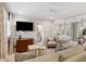 Spacious living room with a TV, sofa, and doorway to a bedroom and bathroom at 3930 Red Rock Way, Sarasota, FL 34231
