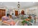 Spacious living room with elegant furniture, a decorative rug, and an open dining area at 3930 Red Rock Way, Sarasota, FL 34231