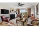 Cozy living room with a fireplace, neutral color palette, eclectic furniture, and views from the French doors at 3930 Red Rock Way, Sarasota, FL 34231